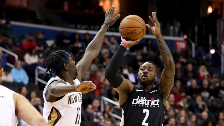 John Wall #2 of the Washington Wizards shoots in front of Jrue Holiday #11 of the New Orleans Pelicans during the first half at Capital One Arena on November 24, 2018 in Washington, DC.