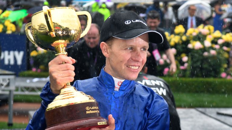 Jockey Kerrin McEvoy holds the Cup in the mounting yard after winning the Melbourne Cup on British horse Cross Counter in Melbourne on November 6, 2018