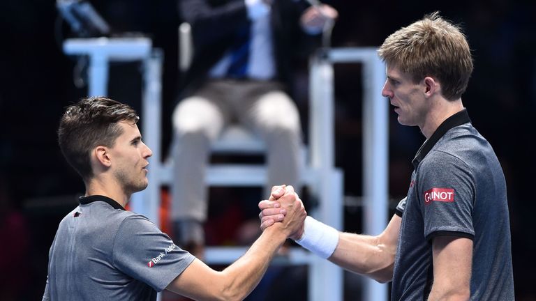 Kevin Anderson (R) greets Belgium's Dominic Thiem after winningn 6-3, 7-6 in their singles round robin match on day one of the ATP World Tour Finals tennis tournament at the O2 Arena in London on November 11, 2018.
