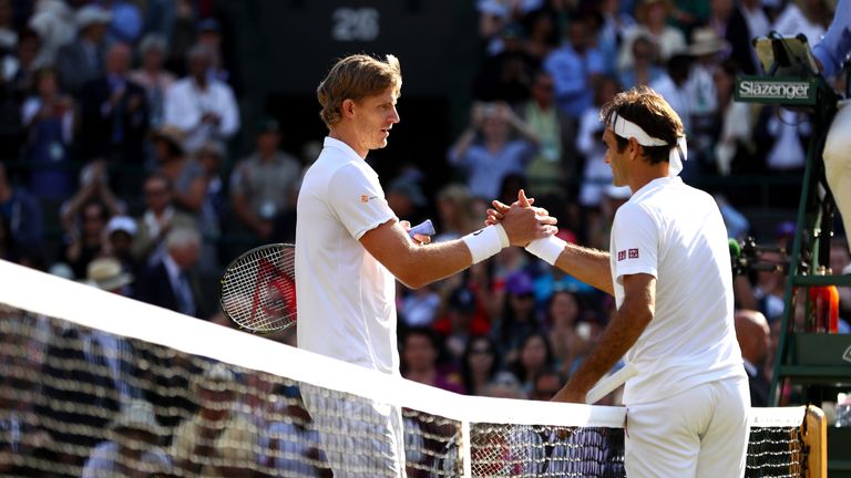Kevin Anderson of South Africa and Roger Federer of Switzerland embrace at the net following their Men&#39;s Singles Quarter-Finals match on day nine of the Wimbledon Lawn Tennis Championships at All England Lawn Tennis and Croquet Club on July 11, 2018