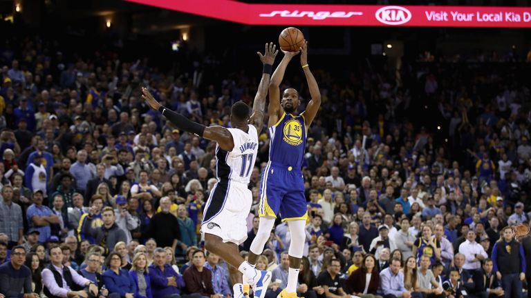 Kevin Durant #35 of the Golden State Warriors shoots over Jonathon Simmons #17 of the Orlando Magic at ORACLE Arena on November 26, 2018 in Oakland, California