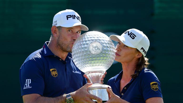 Lee Westwood of England and caddie and partner Helen Storey kiss the trophy after Lee Westwood wins during Day Four of the Nedbank Golf Challenge at Gary Player CC on November 11, 2018 in Sun City, South Africa