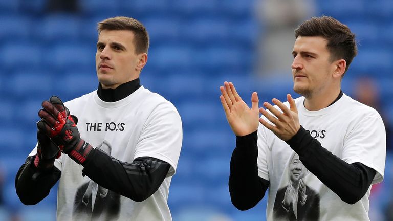Harry Maguire, right, and goalkeeper Eldin Jakupovic applaud supporters