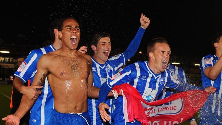 Lewis Dunk (middle) celebrates promotion to the Championship at the Withdean Stadium 