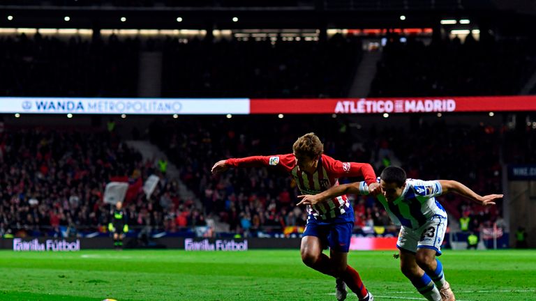 Luca Sangalli (R) jostles with Atletico Madrid's Antoine Griezmann
