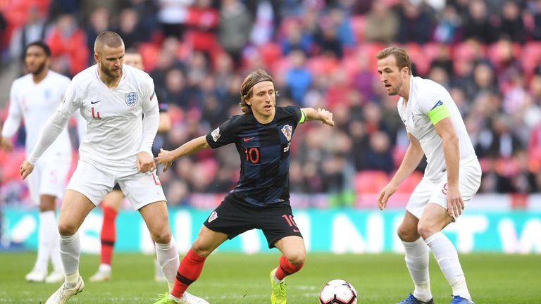 Luka Modric gets away from Eric Dier and Harry Kane