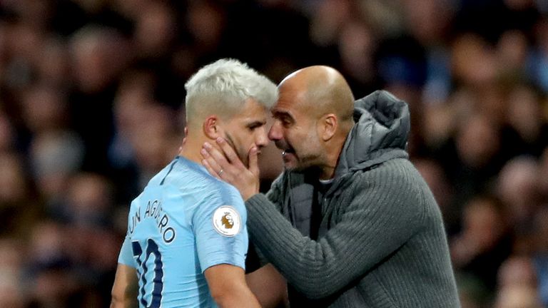 Manchester City manager Pep Guardiola (right) speaks to Sergio Aguero (left)