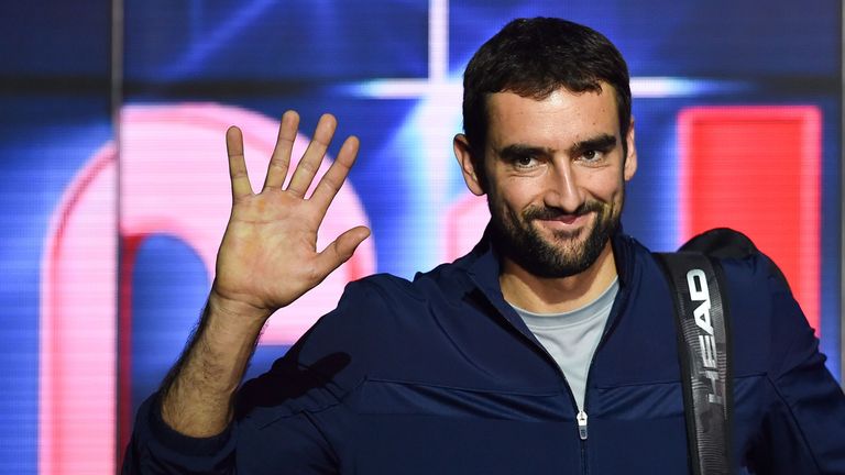Marin Cilic walks on the court to play against US player John Isner during their men's singles round-robin match on day four of the ATP World Tour Finals tennis tournament at the O2 Arena in London on November 14, 2018