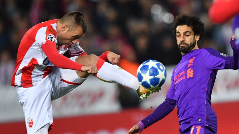 Red Star Belgrade midfielder Nenad Krsticic (L) vies for the ball with Liverpool forward Mohamed Salah
