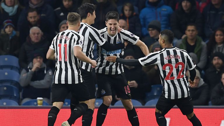Newcastle players celebrate taking the lead at Turf Moor