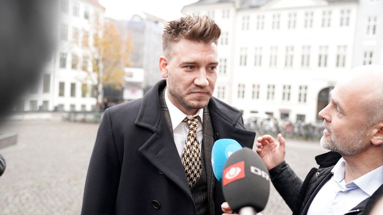 Nicklas Bendtner and lawyer Anders Nemeth talk to the media as they arrive for a hearing at Copenhagen City Council