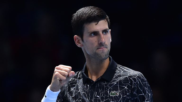 Novak Djokovic reacts after breaking the serve of US player John Isner to go 3-2 in the first set, during their men&#39;s singles round-robin match on day two of the ATP World Tour Finals tennis tournament at the O2 Arena in London on November 12, 2018