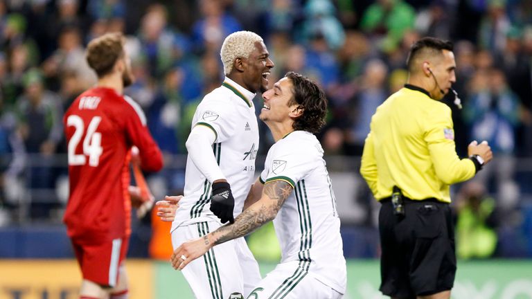 Nov 8, 2018; Seattle, WA, USA; Portland Timbers forward Dairon Asprilla (27) and defender Zarek Valentin (16) celebrate after winning a penalty shootout against the Seattle Sounders FC at CenturyLink Field. Mandatory Credit: Joe Nicholson-USA TODAY Sports