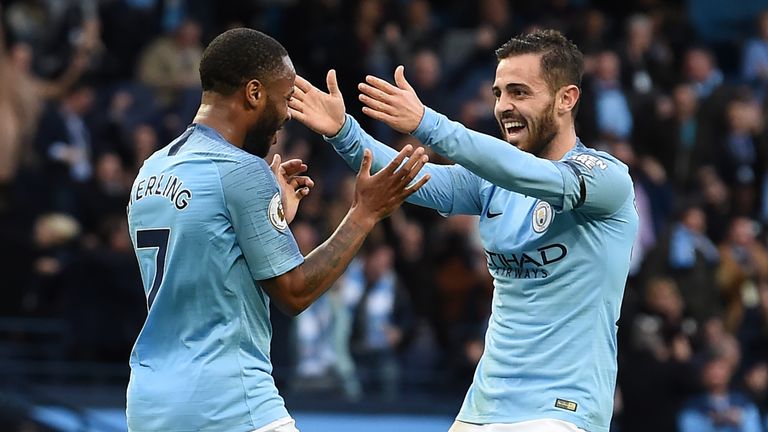 Raheem Sterling celebrates with Bernardo Silva after scoring Manchester City's fourth before half-time