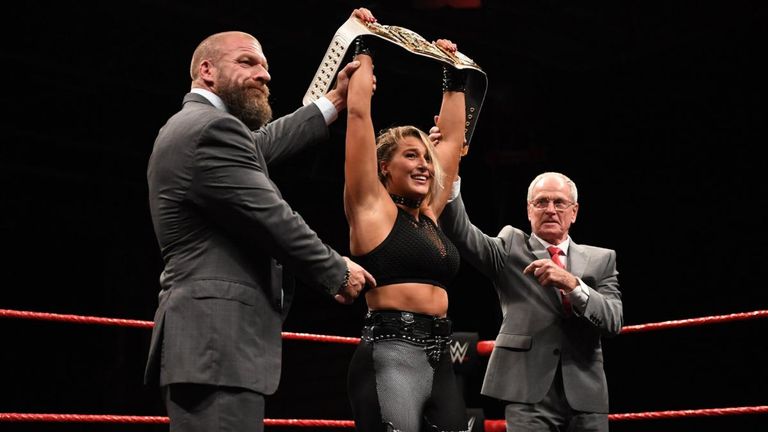 Rhea Ripley is presented with the NXT UK women's championship by Triple H and NXT UK general manager Johnny Saint