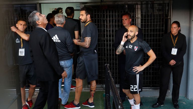 River Plate player Javier Pinola speaks on the phone the match was postponed