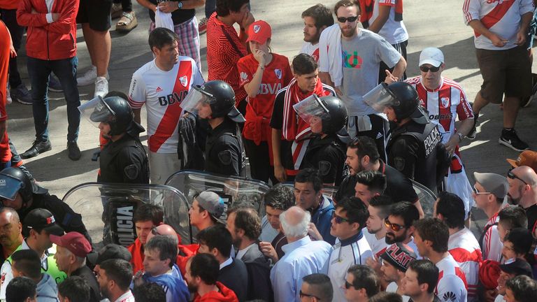 River Plate fans leave the stadium after the match was postponed