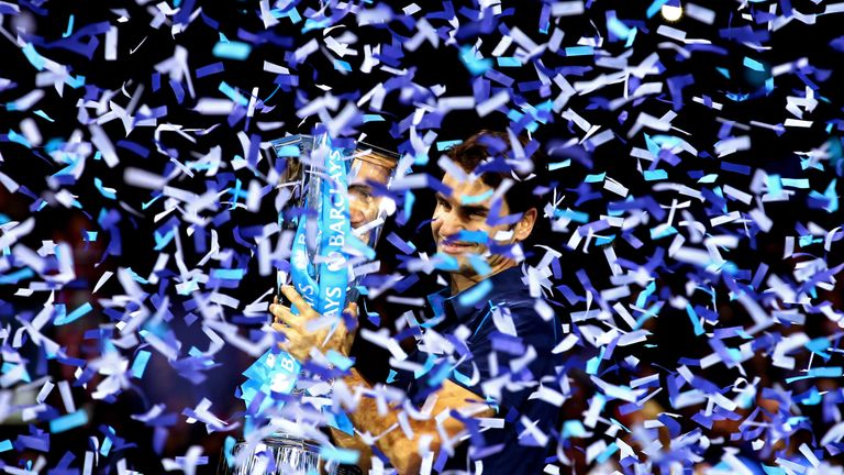 Roger Federer lifts the trophy following his victory over Jo-Wilfried Tsonga in the final of the ATP World Tour Finals in 2011