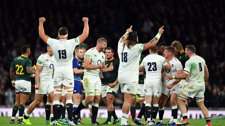 England's players celebrate after holding on to defeat South Africa