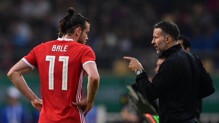 Wales' head coach Ryan Giggs (R) talks with Wales' Gareth Bale during their China Cup International Football Championship final match against Uruguay in Nanning in China's southern Guangxi region on March 26, 2018.