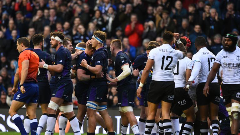 Scotland players celebrate their first try scored by prop Allan Dell