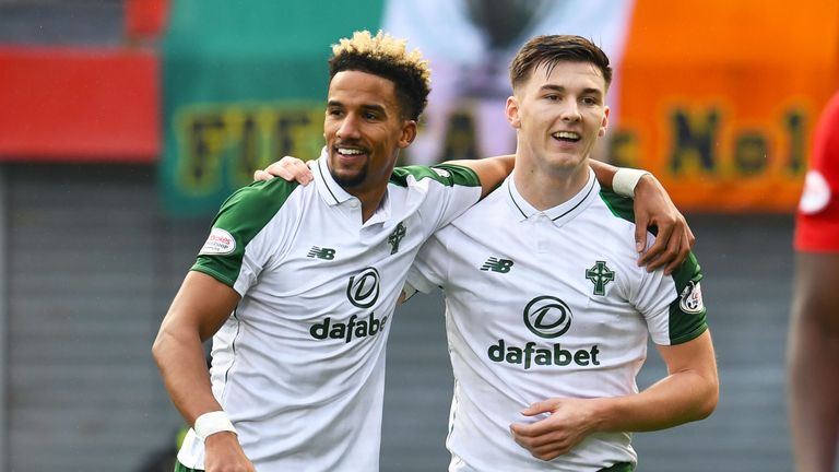 Scott Sinclair (L) celebrates Hamilton's own goal with Kieran Tierney