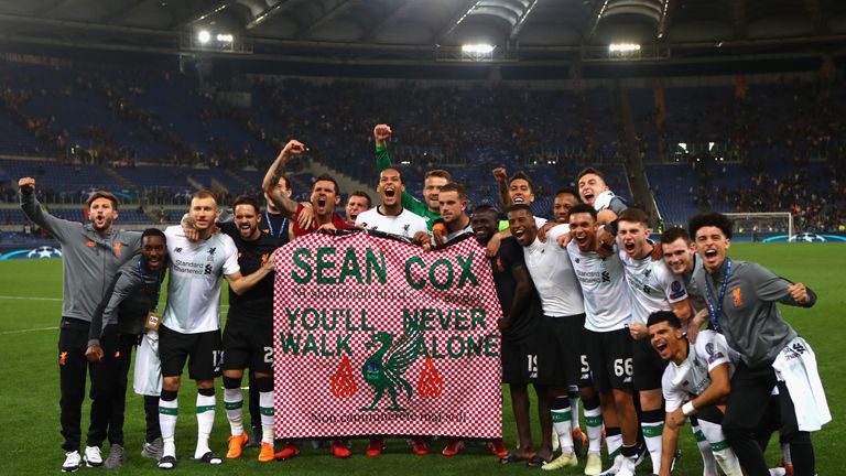 Liverpool players celebrate with a Sean Cox banner after their Champions League semi-final victory over Roma