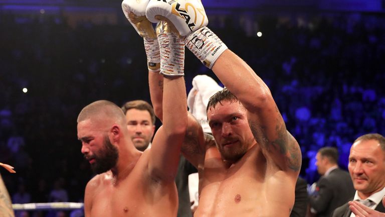 Oleksandr Usyk of Ukraine holds up Tony Bellew of England arm after beating him after the WBC, WBA, WBO, IBF & Ring Magazine World Cruiserweight Title Fight between Oleksandr Usyk and Tony Bellew at Manchester Arena on November 10, 2018 in Manchester, England. 