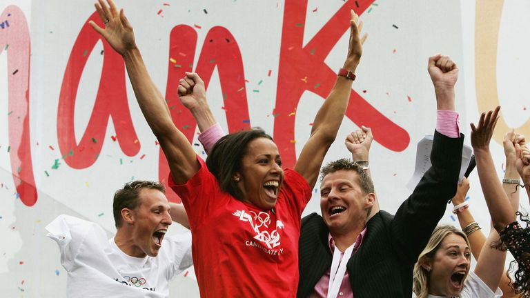 LONDON - JULY 6:  (Lt to Rt) Danny Crates, Dame Kelly Holmes and Steve Cram jump for joy as they hear the good news that London win the Olympic 2012 bid during the Public Viewing For the International Olympic Committee Decision at Trafalgar Square on July 6, 2005 in London, England. London won a two-way fight with Paris by 54 votes to 50 at the IOC meeting in Singapore, after bids from Moscow, New York and Madrid were eliminated. (Photo by Christopher Lee/Getty Images) *** Local Caption *** Danny Crates;Dame Kelly Holmes;Steve Cram