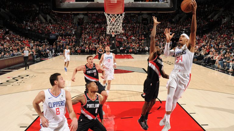 Tobias Harris attempts a hook shot in the lane against Portland