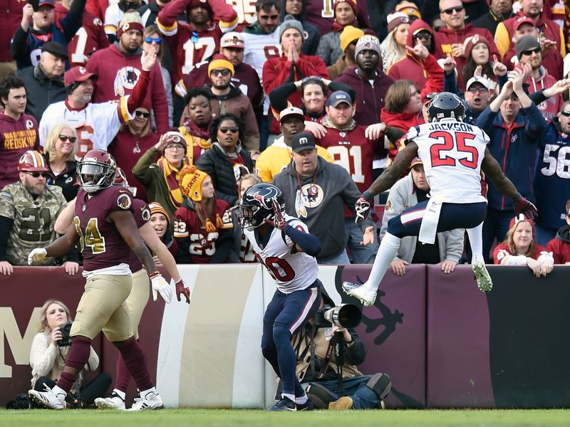 Houston Texans strong safety Kareem Jackson (25) reaches for Washington  Redskins quarterback Alex Smith (11) as he leaves the field after an injury  during the second half of an NFL football game, …