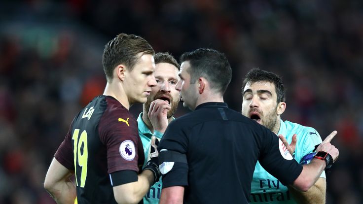 Arsenal players surround the referee against Liverpool