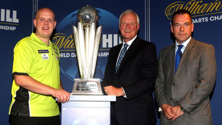 Chief Marketing Officer at William Hill Kristof Fahy (R) and Michael van Gerwen of Holland (L) and PDC Chairman Barry Hearn (C) pose for a photo with the Sid Waddell trophy during William Hill World Darts Championship Sponsorship Launch at Rileys Sports Bar on June 13, 2014 in London, England. 