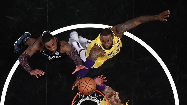 LeBron James fights for a rebound against Brooklyn