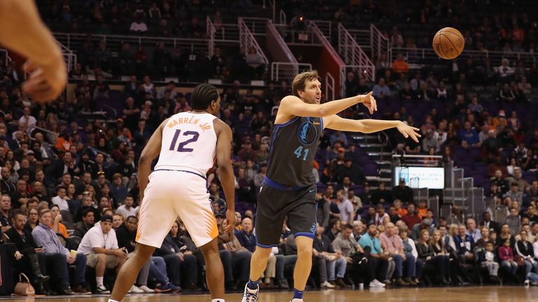 Dirk Nowitzki passes the ball during his season debut