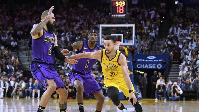 Stephen Curry dribbles past Tyson Chandler