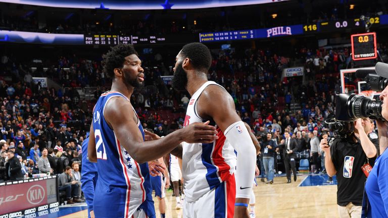 Joel Embiid engages with Andre Drummond after the Sixers beat the Pistons