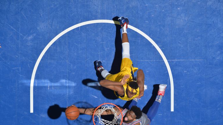 Joel Embiid finishes at the rim against Indiana