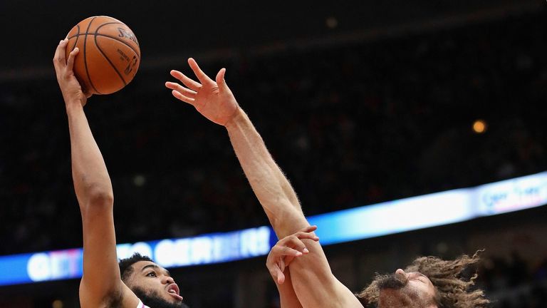 Karl-Anthony Towns lofts a hook shot over Robin Lopez
