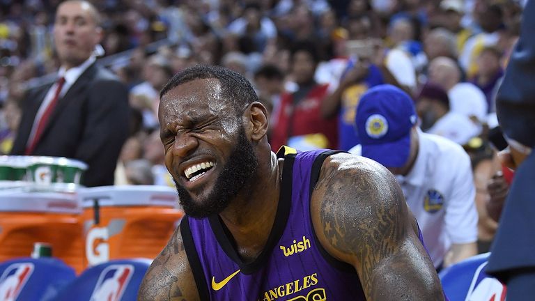 LeBron James reacts after leaving the game with a groin injury