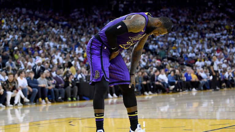 LeBron James clutches his groin during the Los Angeles Lakers' win over the Golden State Warriors