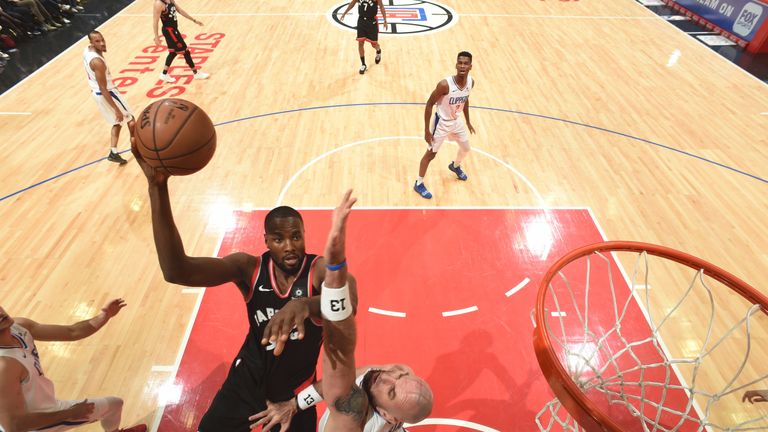 Serge Ibaka scores on Clippers center Marcin Gortat