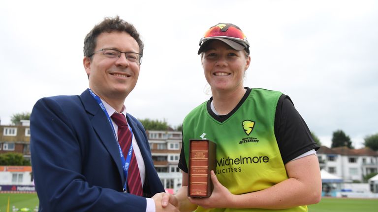 Wisden editor Lawrence Booth hands Anya Shrubsole her leather-bound copy