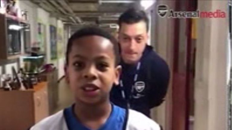 Mesut Ozil surprises a young Arsenal fan at a London primary school.