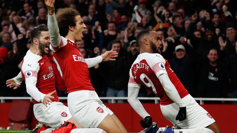 Alex Lacazette celebrates scoring the 3rd Arsenal goal with (L) Matteo Guendouzi and (R) Sead Kolasinac during the Premier League match between Arsenal FC and Tottenham Hotspur at Emirates Stadium on December 1, 2018 in London, United Kingdom. 