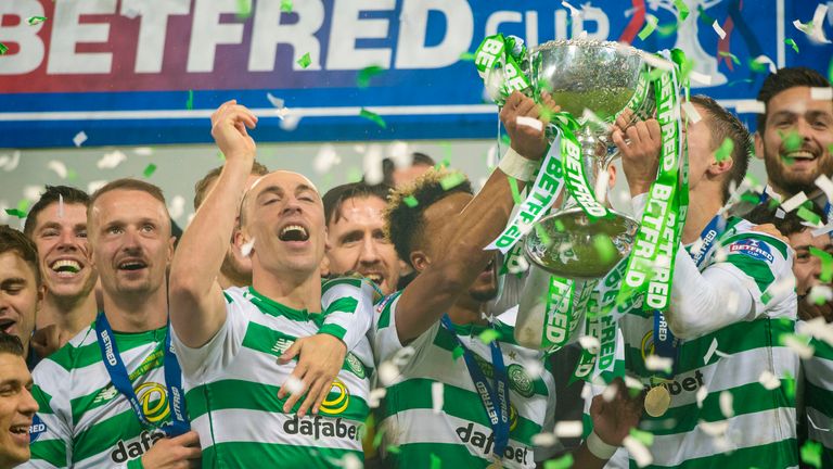 Celtic players celebrate with the Scottish League Cup