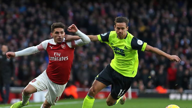 Chris Lowe battles for possession with Lucas Torreira