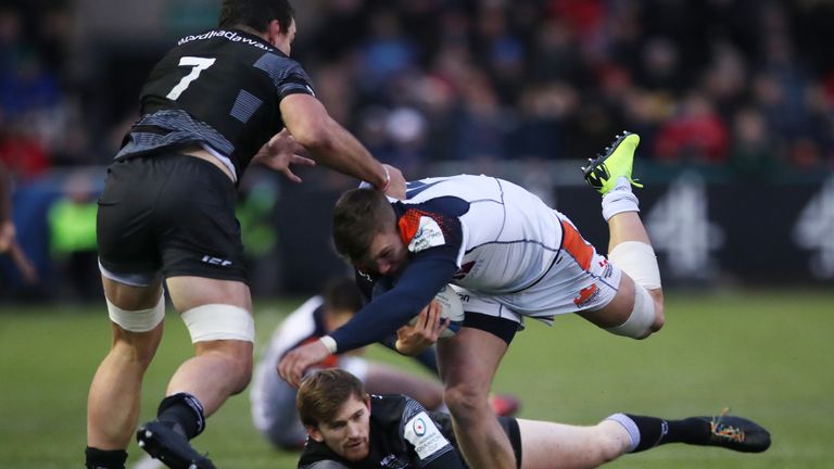  Darcy Graham of Edinburgh Rugby is tackled by Newcastle's John Hardie 