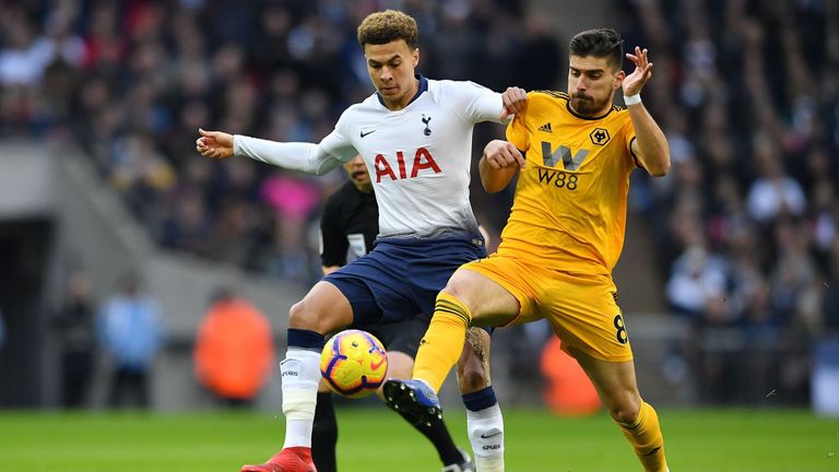 Dele Alli vies for the ball with Ruben Neves
