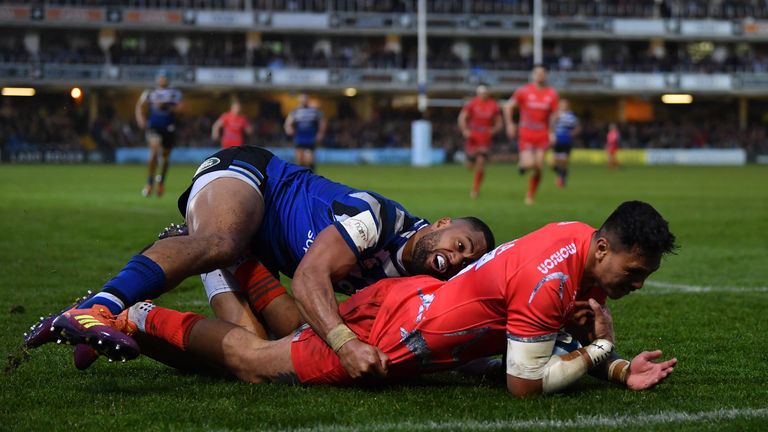 Denny Solomona of Sale Sharks knocks the ball on short of the try line as he is tackled by Joe Cokanasiga of Bath during the Gallagher Premiership Rugby match between Bath Rugby and Sale Sharks at the Recreation Ground on December 02, 2018 in Bath, United Kingdom.